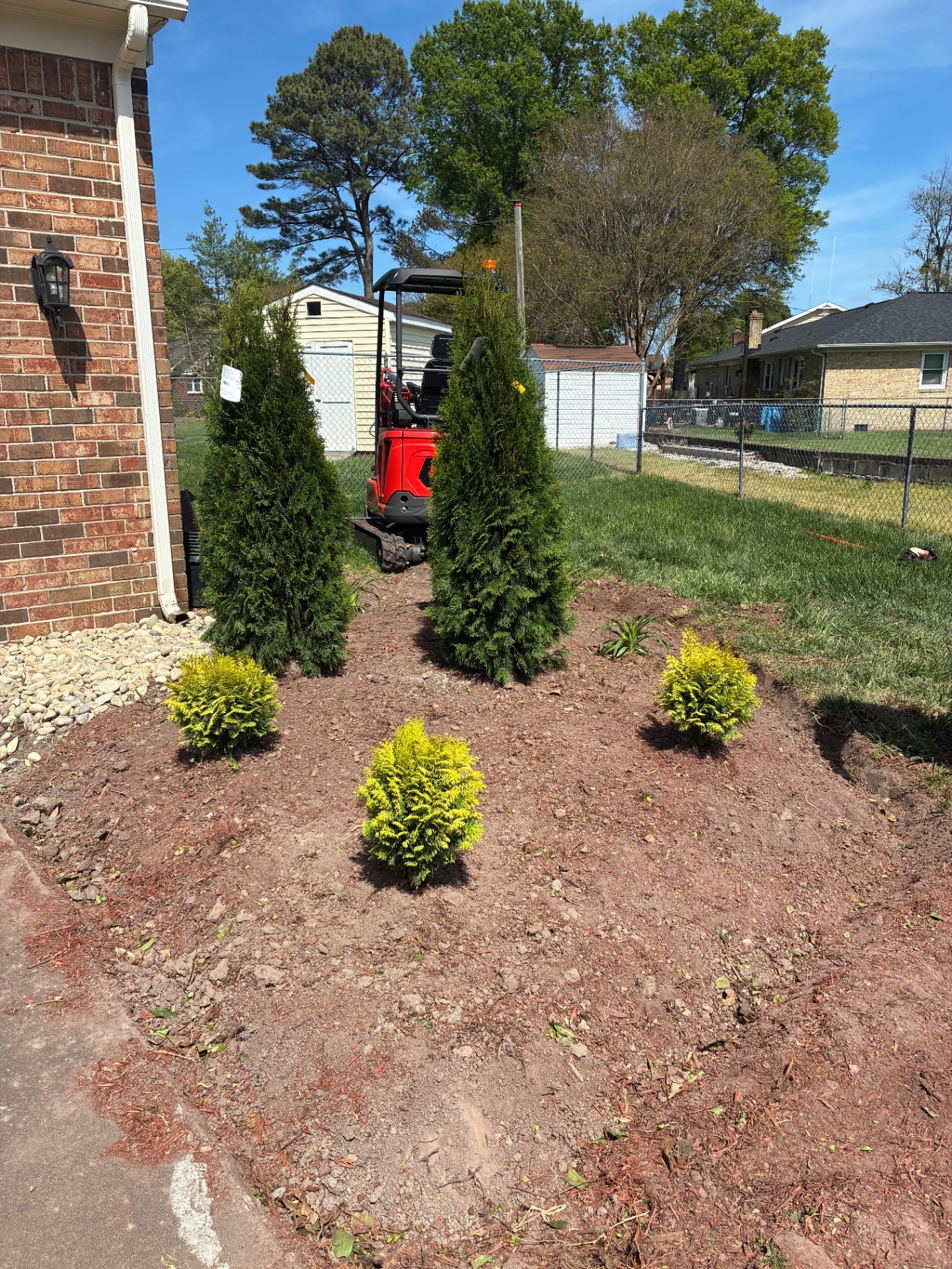 Fresh landscaping with evergreen plantings and mulch restoration